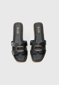 Black slip-on sandals with two wide straps featuring a gold buckle. The insole is padded, and the sole is flat with a tan edge.