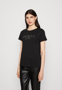 Guess - 1981 CRYSTAL EASY TEE - Nyomott mintás póló - jet black Miniatűr kép 1