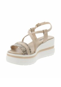 Sandali platform beige con fasce incrociate, una banda decorata e suola in gomma bianca. Presentano una cinghia alla caviglia regolabile per una vestibilità ottimale.
