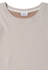 Close-up of beige and white textured knit top with round neckline and CECIL brand label inside collar.