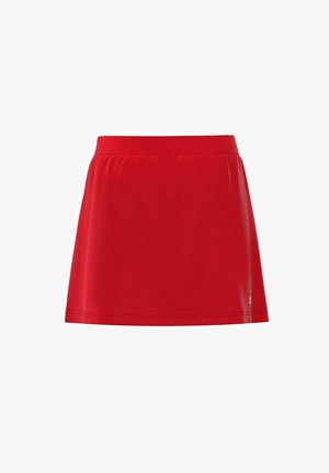 Jupe de sport rouge en tissu lisse et léger. Elle possède une taille élastique douce et une forme évasée en A pour faciliter les mouvements.
