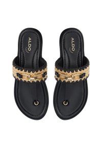 Black flat slide sandals with woven natural fiber strap, gold-tone hardware, and textured black insole.