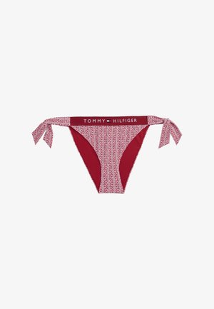 Rød bikini-bukse med mønstret front, ensfarget bak og sløyfer på hver side. Midjebåndet har "TOMMY HILFIGER" logoen.