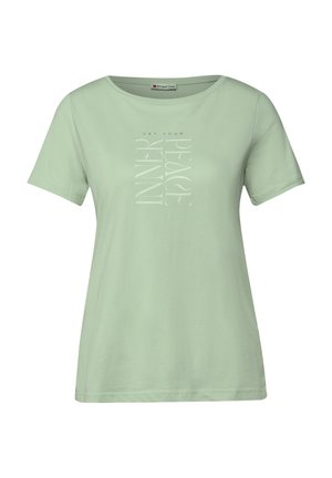 T-shirt vert menthe à manches courtes en tissu doux. Présente un design graphique vertical en blanc avec le texte "TROUVEZ VOTRE PAIX INTÉRIEURE."