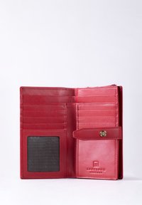 Red leather wallet with multiple card slots, a transparent ID window, and a snap closure. Embossed brand logo in the bottom corner.