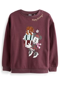 Sweat-shirt bordeaux avec un graphisme d'un personnage tenant des cadeaux emballés et un accent floral. Le texte indique "Joyeuses fêtes !" en doré.