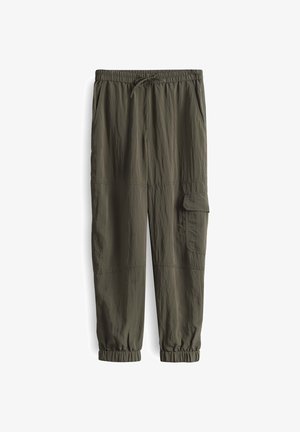 Olivgrüne Jogginghosen aus strukturiertem Stoff. Mit elastischem Bund und Kordelzug, Seitentaschen und schmal zulaufenden Bündchen.