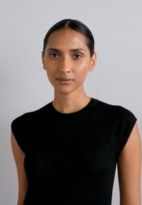 Black short-sleeve top with a crew neckline and fitted silhouette, made of a soft, smooth fabric. Simple design with no patterns or accents.