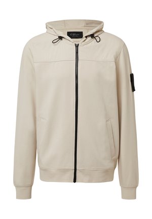 Beige zip-up hoodie met een trekkoordcapuchon, twee zijzakken, geribde manchetten en een klein zwart stoffen label op de mouw. Glad van textuur.