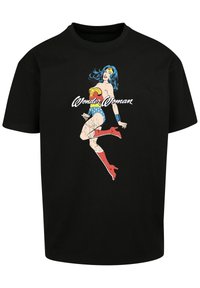 Black cotton t-shirt featuring a vintage Wonder Woman graphic in color, with her iconic red boots and blue star-patterned shorts.