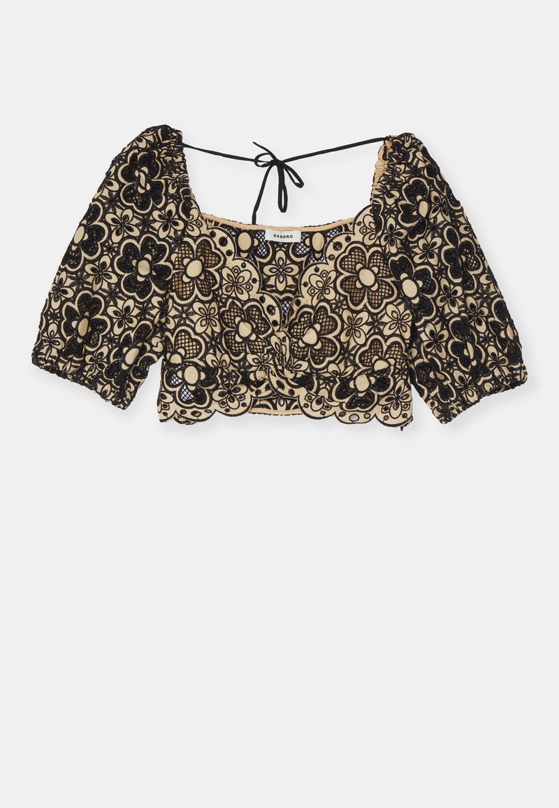 Black floral-embroidered cropped top with puff sleeves, square neckline, and tie detail at the back. Intricate lace pattern on a beige background.