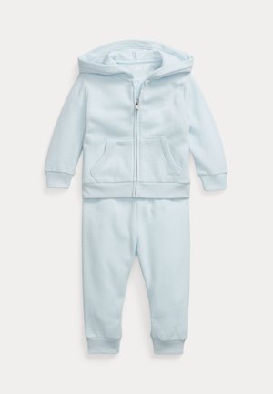 Completo in cotone azzurro chiaro composto da felpa con zip e tasca a marsupio, polsini a costine e pantaloni abbinati con vita elastica.