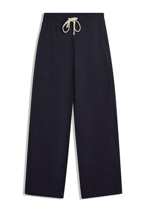 Námorníckomodré bavlnené tepláky s voľným strihom, elastickým pásom a krémovou šnúrkou na stiahnutie. Obsahujú bočné vrecká a prešívaný lem.