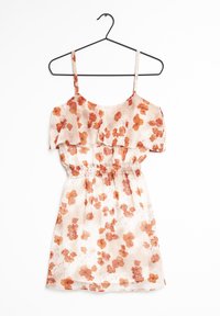 Robe florale en tissu léger et transparent avec une taille élastique. La palette de couleurs comprend un beige doux avec des fleurs oranges et des bretelles froncées.