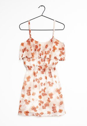 Bloementuniek met een lichte, doorzichtige stof en een elastische tailleband. Het kleurenpalet omvat zacht beige met oranje bloemen en gerimpelde schouderbanden.