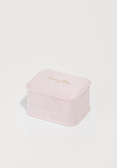 Pink textile jewelry box with smooth texture, rectangular shape, gold embossed logo on the lid, stitched edges, and compact design.