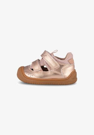 Rose gold children's sandal with two Velcro straps, perforated sides, brown rubber sole, and textured accents. Lightweight and breathable design.