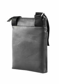 Sac en cuir noir au design minimaliste, doté d'une fermeture éclair supérieure, de sangles noires contrastantes et d'une texture lisse.