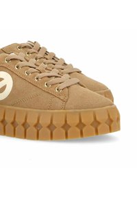 Brown suede sneakers with a thick, textured gum rubber sole featuring diamond patterns and gold eyelets for laces.