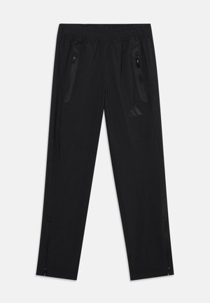 Black athletic pants with elastic waistband, zippered side pockets, and ankle zippers, designed for sport and casual wear.