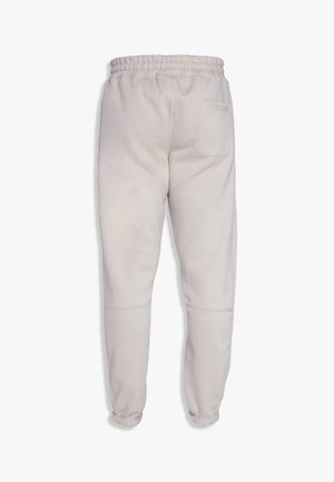 Hellgraue Sweatpants mit einem dehnbaren Bund, gerippten Bündchen und einer einzigen Gesäßtasche. Hergestellt aus weichem Stoff mit glatter Textur.