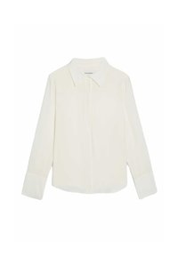 Camisa de color crema con cuello puntiagudo, mangas largas y puños en contraste. Tejido suave con un diseño minimalista, sin patrones.