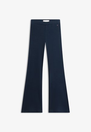 Pantalon en maille côtelée bleu marine avec jambe évasée et petit logo brodé près de la ceinture, posé à plat sur un fond blanc.