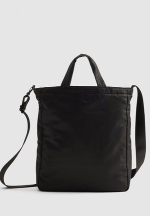 Black nylon tote bag with short handles and a detachable shoulder strap, featuring a sleek, quilted design and minimal hardware accents.