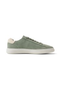 Zapatilla de caña baja verde oliva con parte superior de ante perforado, lengüeta beige en el talón, cierre de cordones y suela de goma blanca, vista lateral sobre fondo blanco.