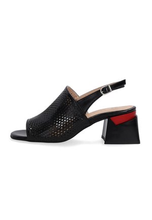 Black perforated slingback shoe with an open toe, featuring a low, block heel with a red accent and a buckle closure.