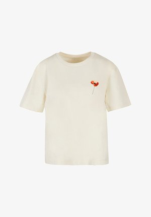 Kreemit värvi puuvillane T-särk lühikeste varrukatega, millel on vasakul rinnal väike punane ja roosa lillekujundus. Lihtne, mugav lõige.