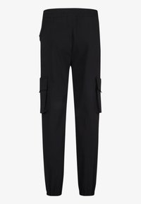 Pantalon cargo noir avec taille élastique et poignets au niveau des chevilles, avec grandes poches à rabat de chaque côté.