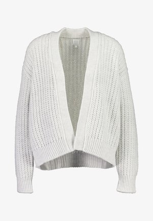 Valkoinen neulottu neuletakki, jossa on väljä istuvuus, avoin etu ja resorit hihansuissa. Siinä on teksturoitu kuvio ja lyhyt pituus.