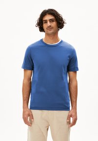 Korte mouwen crewneck t-shirt in levendig blauw katoen. Heeft een gladde textuur en een klassieke pasvorm. Gekocht met lichtgekleurde cargobroeken.