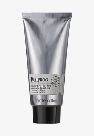 Metallischer silberner Tubenbehälter für Rasierschaum, ausgestattet mit schwarzem Boden und weißem Etikett mit Text. Inhalt: 100ml (3,38 fl. oz.).