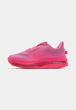 Nike running shoe featuring a mesh upper in vibrant pink with gradient accents, visible air unit, and textured sole for traction.