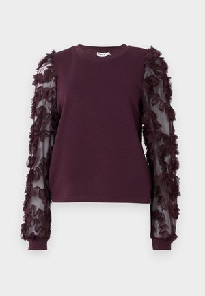 Sweatshirt bordeaux avec des manches transparentes ornées de fleurs en tissu froncé. Encolure ronde et poignets ajustés complètent le design.