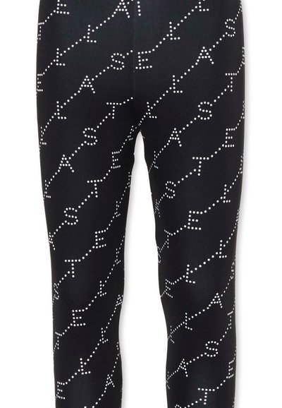 Leggings noirs avec des lignes blanches en pointillés formant des motifs diagonaux du mot "STELLA" répété sur tout le tissu.
