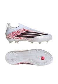 Fehér focicipők piros virágmintával, fekete Adidas csíkokkal és áttetsző stoplikkal a talpon, oldalról és alulnézetből bemutatva.