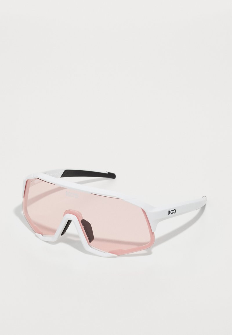 Sports sunglasses with a white plastic frame, pink tinted lenses, and black accents. Features angular design and large lens coverage.