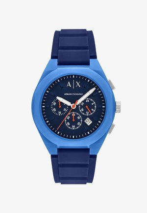 Orologio in silicone blu con cassa rotonda, quadrante blu scuro, dettagli in argento, tre sottodial e visualizzazione della data alle 4.