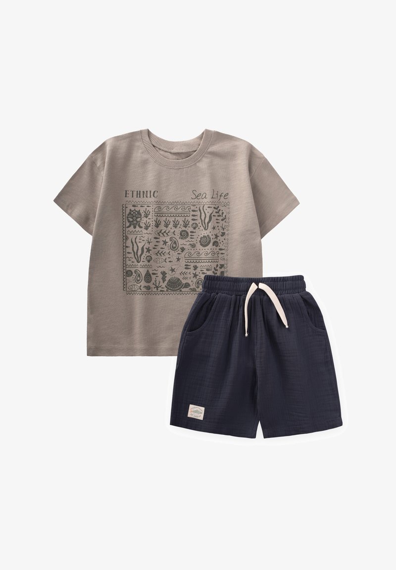 Hallhalli halli T-särk, millel on mereteemaline graafika ja sõna "ETNILINE" koos tumesiniste lühikeste pükste ning elastse vöökoha ja küljetaskutega.