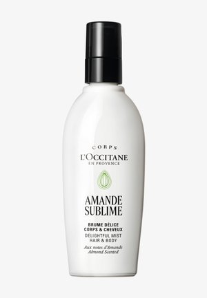 White spray bottle with black cap labeled L'Occitane Amande Sublime delightful mist for hair and body, almond scented, French and English text.