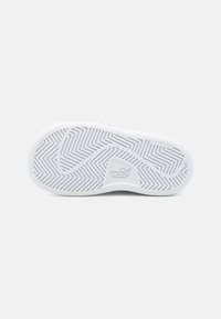 Hvit gummisåle til sneakers med et zigzag-mønster og en liten, synlig logo. Non-marking materiale. Buede kanter med en glatt tekstur.