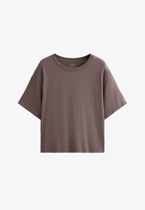 Rjava bombažna majica s sproščenim krojem, kratkimi rokavi in okroglim izrezom. Tkanina se zdi mehka in gladka, brez vidnih vzorcev.