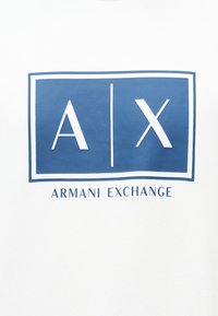 Λογότυπο Armani Exchange με λευκά γράμματα "A | X" μέσα σε μπλε πλαίσιο τετράγωνου σε λευκό φόντο, κείμενο "Armani Exchange" κάτω από το τετράγωνο.