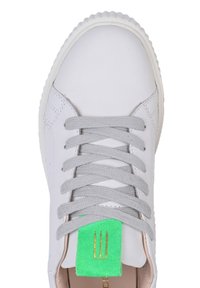 Sneaker bianco in pelle con punta rotonda, lacci grigi e linguetta in suede verde con un'emblema dorato. Suola in gomma texture.