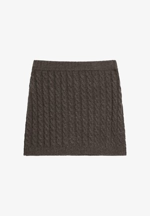 Sukně s pleteným vzorem z tmavě hnědé látky. Má žebrovaný pas a texturovaný vzor po celé ploše. Krátký a přiléhavý střih.