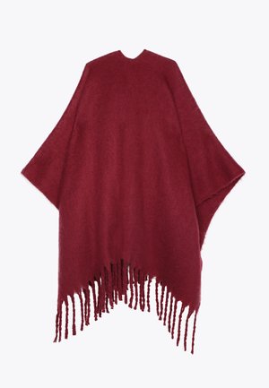 Burgundy poncho made of soft fabric with an open front, featuring long fringes at the hem and a rounded neckline.