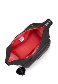 Black nylon bag with a red interior, featuring a zippered closure and a pom-pom keychain detail. Interior has compartmentalized sections.
